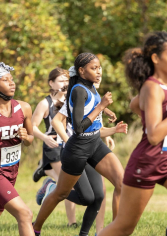 As an all-outdoors event, cross-country could be held without violating COVID-19 safety restrictions during fall, 2021. Jacqueline Braxton, center, ran for Roosevelt. Her preferred events are mid-distance; cross country is typically considered to be a long distance run.